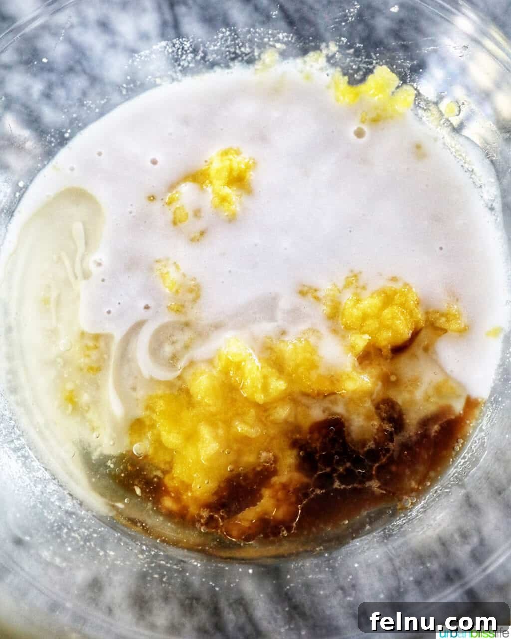 Taisan: Fluffy Filipino Chiffon Cake Perfection 10 Wet ingredients for Taisan cake, including coconut milk and vanilla, in a bowl