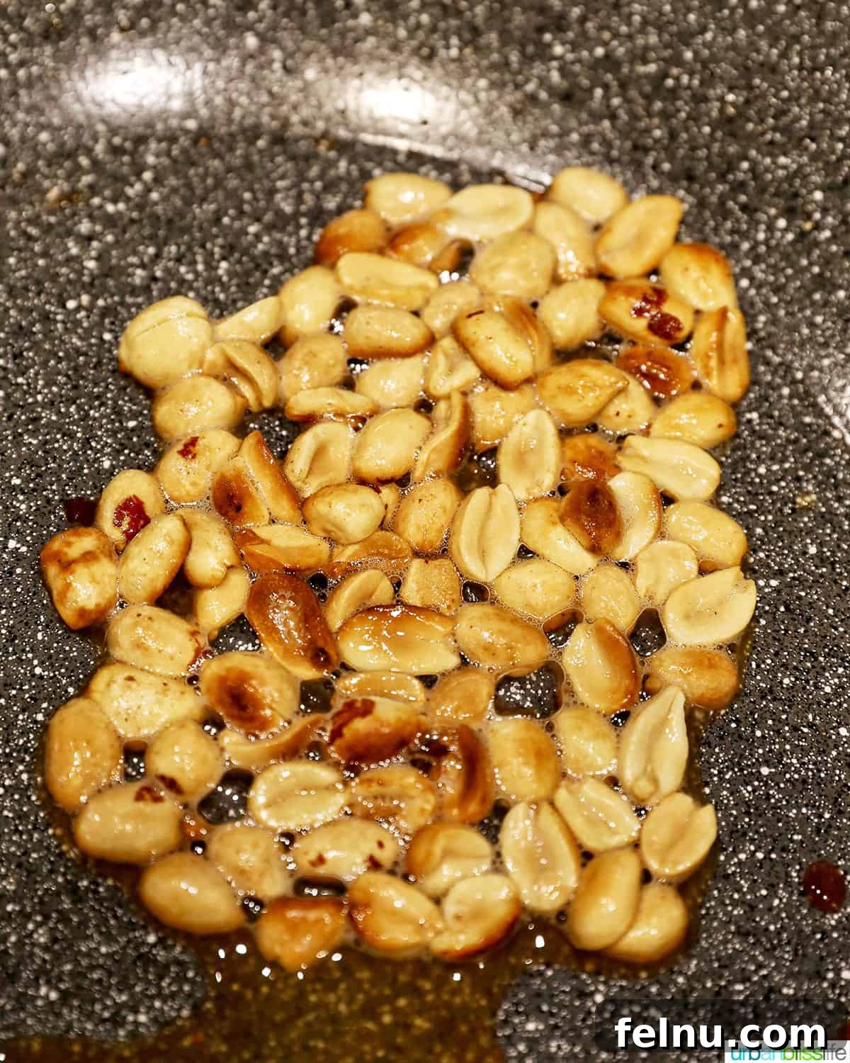 Weeknight Kung Pao Chicken 12 Cooking peanuts in a wok until golden brown