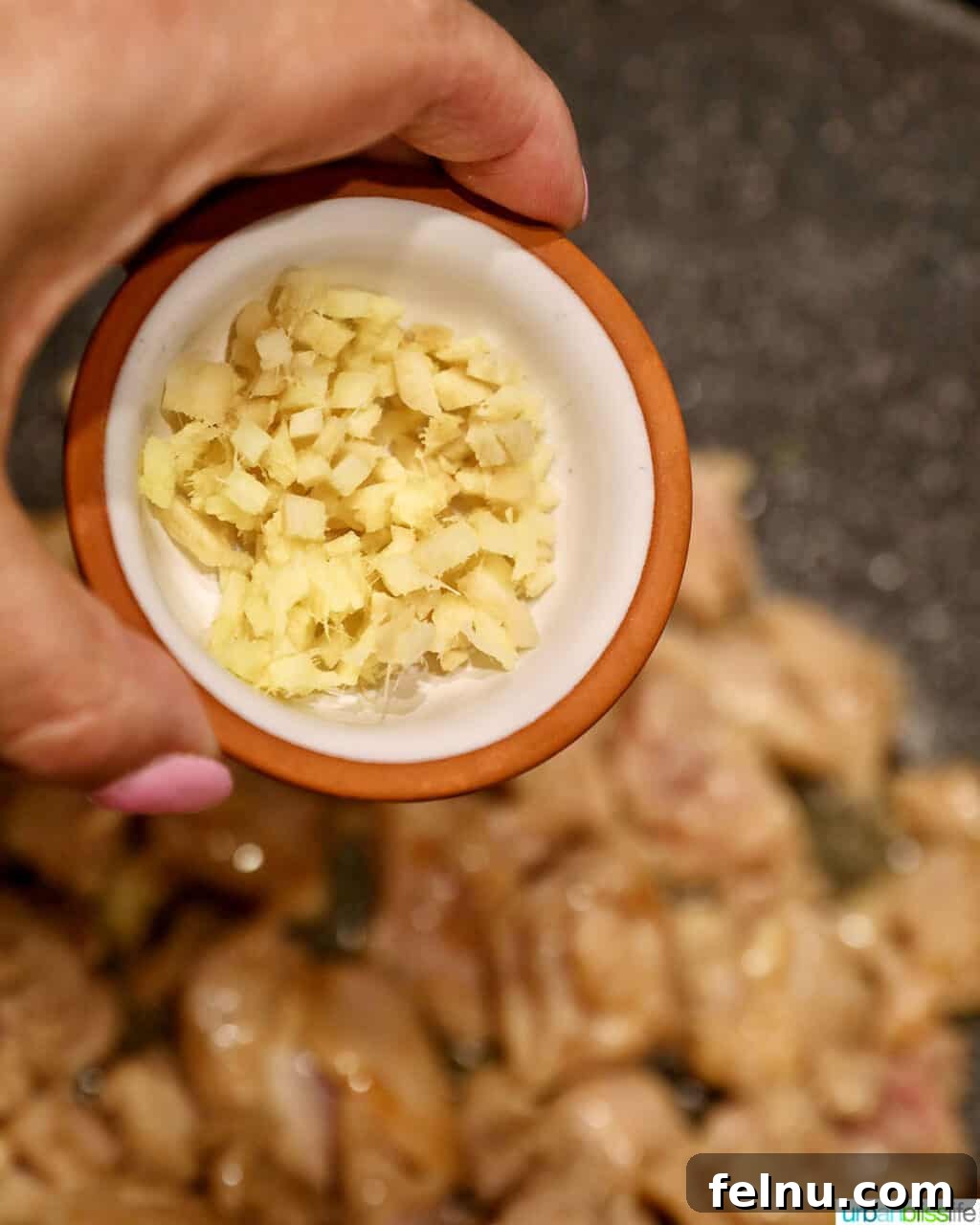 Weeknight Kung Pao Chicken 16 Adding minced fresh ginger to chicken in a wok