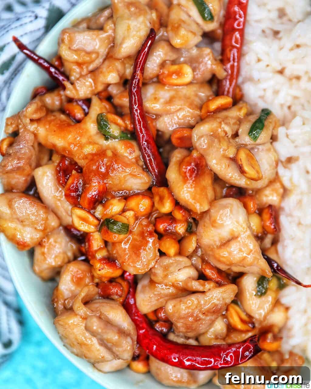 Weeknight Kung Pao Chicken 3 Closeup view of a serving of Kung Pao Chicken with rice, showing the rich sauce and peanuts