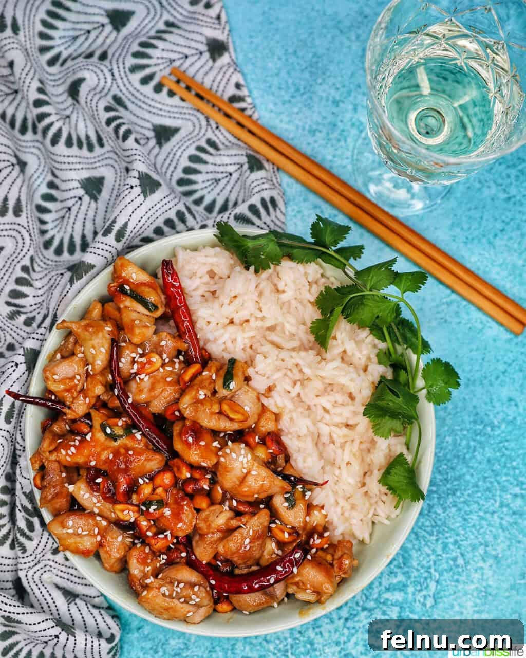 Weeknight Kung Pao Chicken 4 Kung Pao Chicken with rice, chopsticks, and a glass of wine on a table
