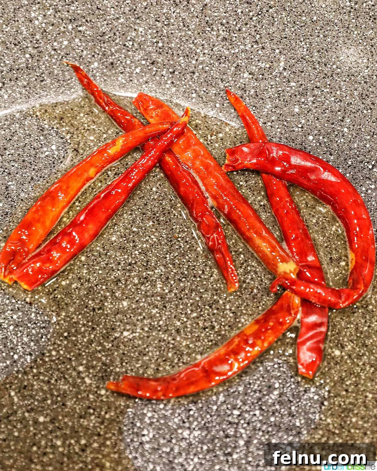 Weeknight Kung Pao Chicken 6 Cooking dried Thai chiles in a wok