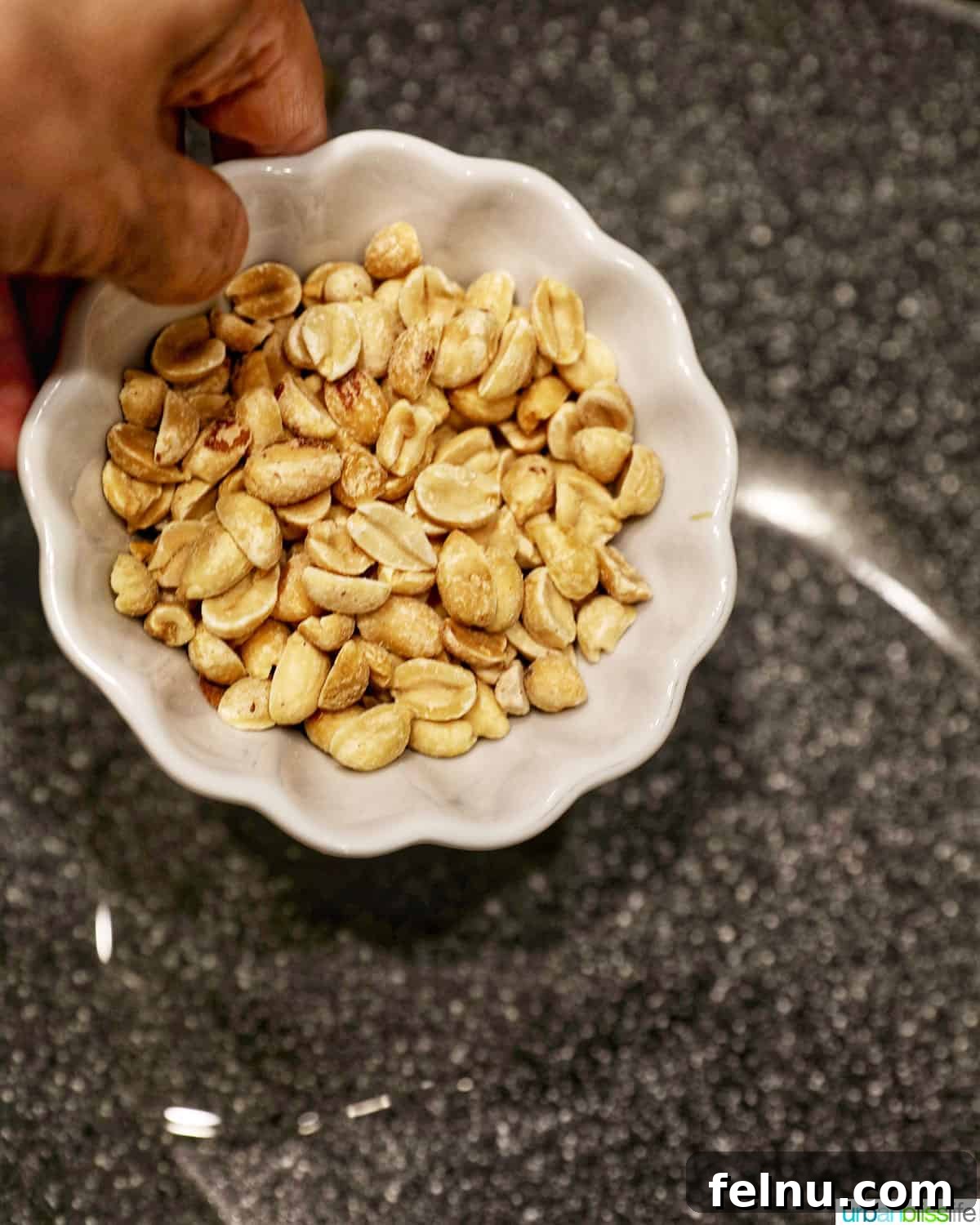 Weeknight Kung Pao Chicken 7 Adding peanuts to a hot pan for Kung Pao Chicken