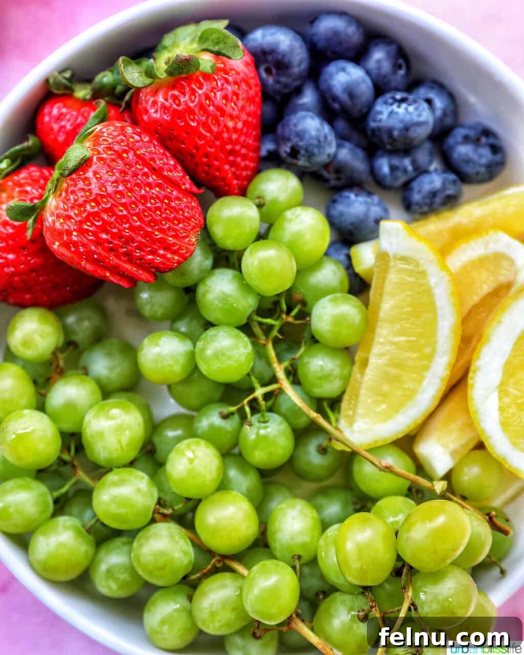 Brunch Grazing Platter 8 A bowl filled with fresh fruits, including grapes, strawberries, and blueberries, providing a vibrant and healthy addition to the brunch board.