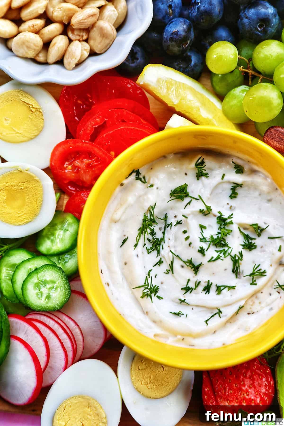 Brunch Grazing Platter 9 A variety of vegetables and fruits surrounding a flavorful dip, adding depth and dimension to the brunch board.
