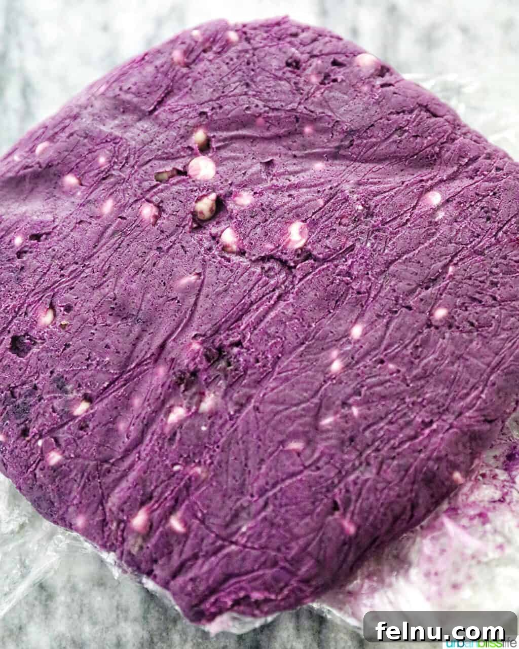 Ube and White Chocolate Dream Cookies 14 Ube cookie dough wrapped in plastic wrap, ready for refrigeration.
