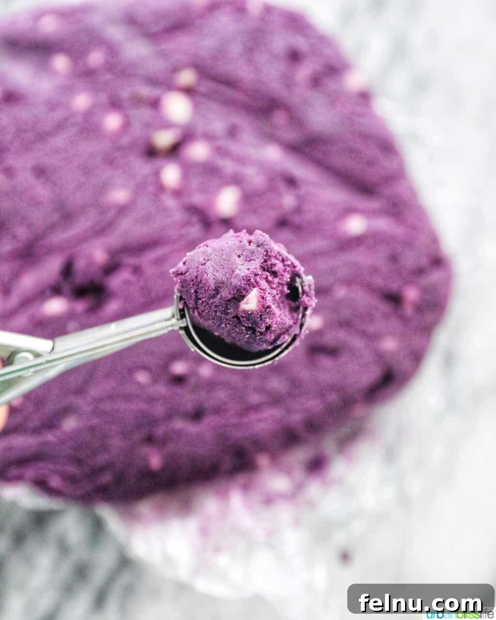 Ube and White Chocolate Dream Cookies 15 Ube cookie dough being scooped onto a baking sheet.