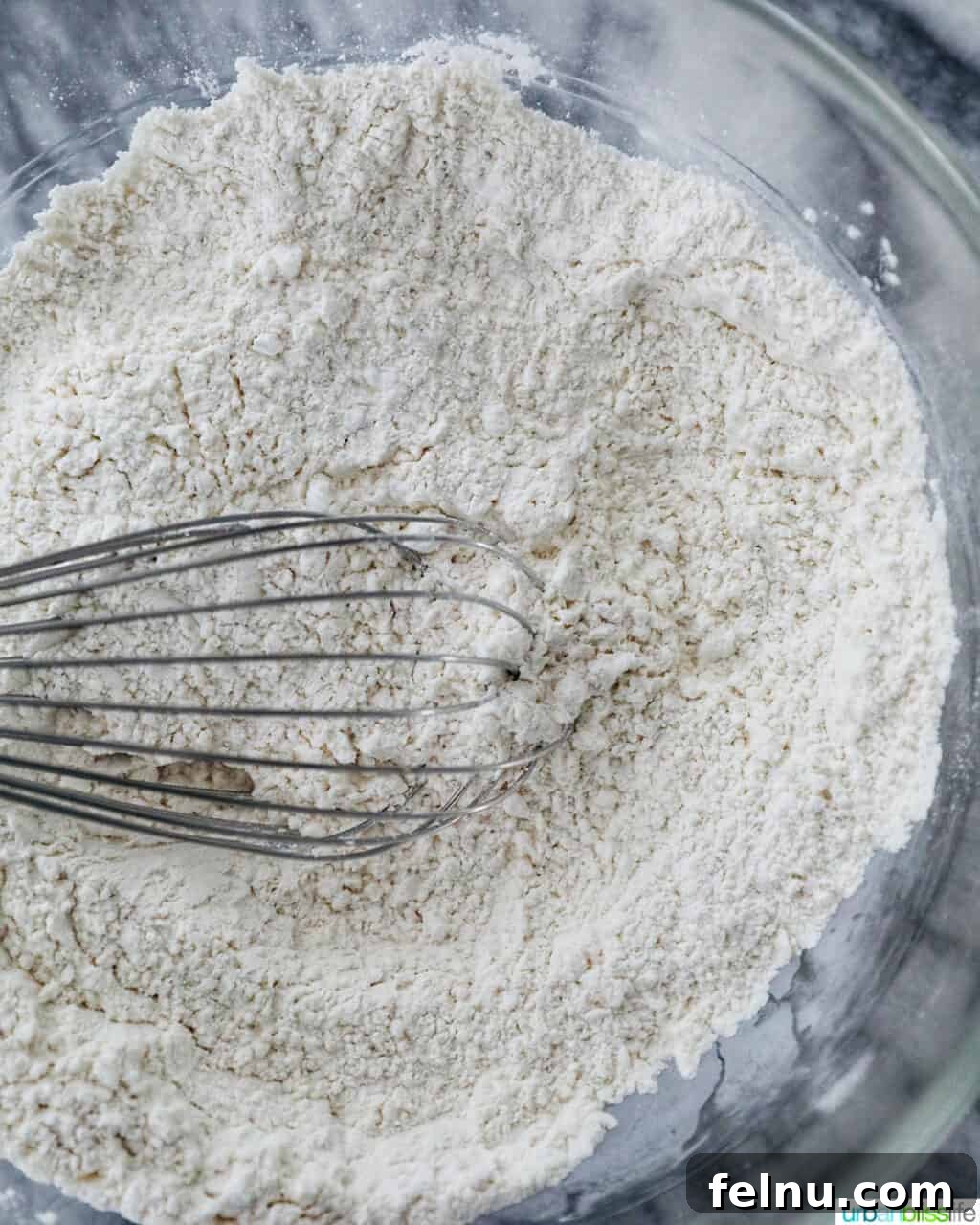 Ube and White Chocolate Dream Cookies 5 Dry ingredients for Ube White Chocolate Chip Cookies being whisked together.