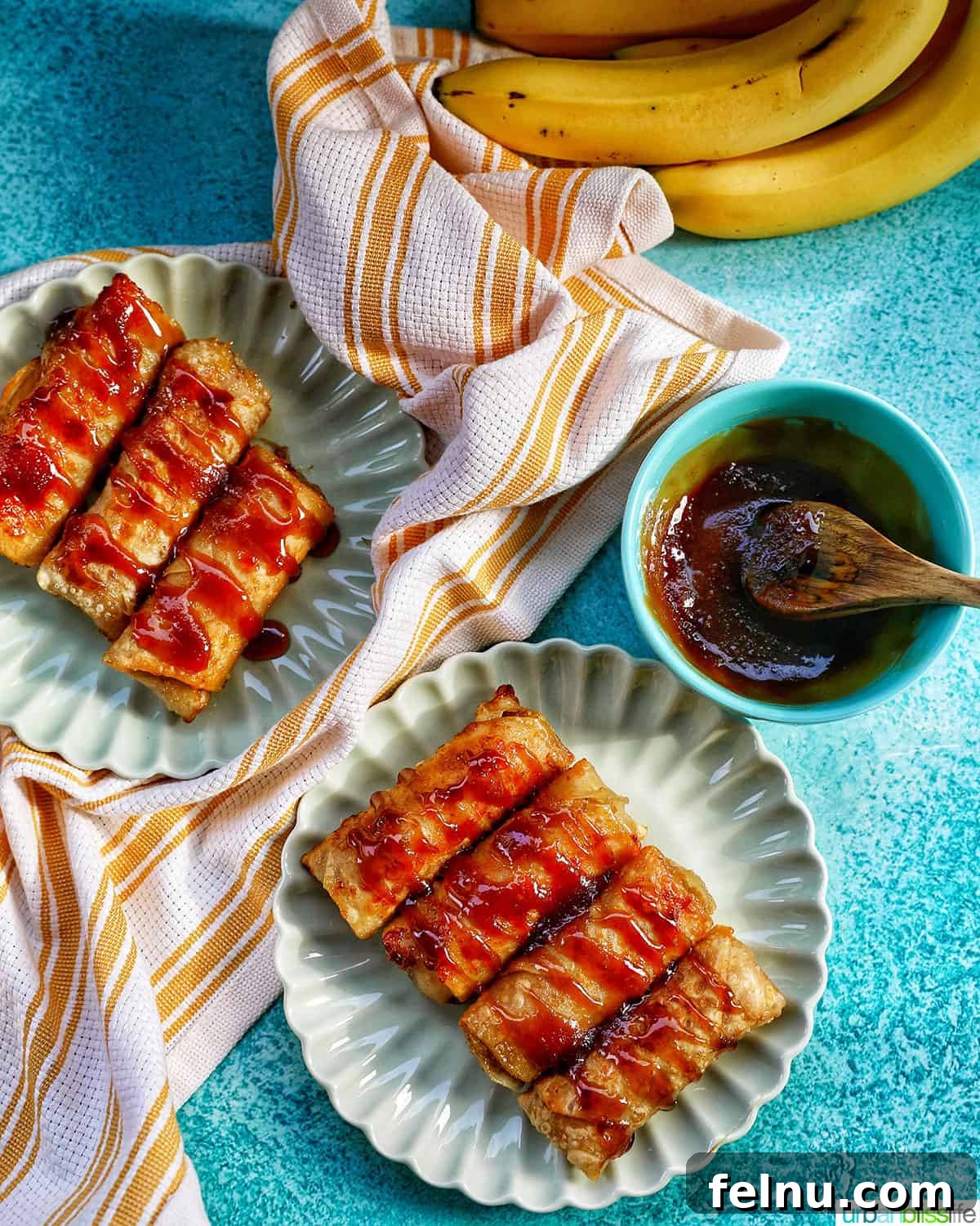 Effortless Filipino Turon: Crispy Banana Lumpia Perfection 22 Plates of Filipino turon banana lumpia with caramel drizzle, ready to serve.