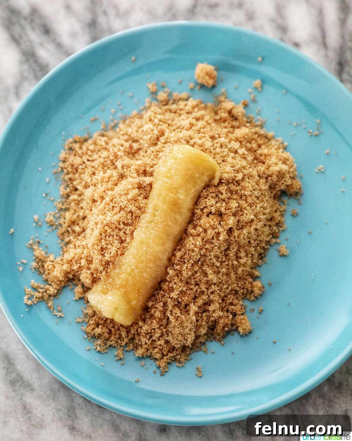 Effortless Filipino Turon: Crispy Banana Lumpia Perfection 7 Coating banana in brown sugar for turon.