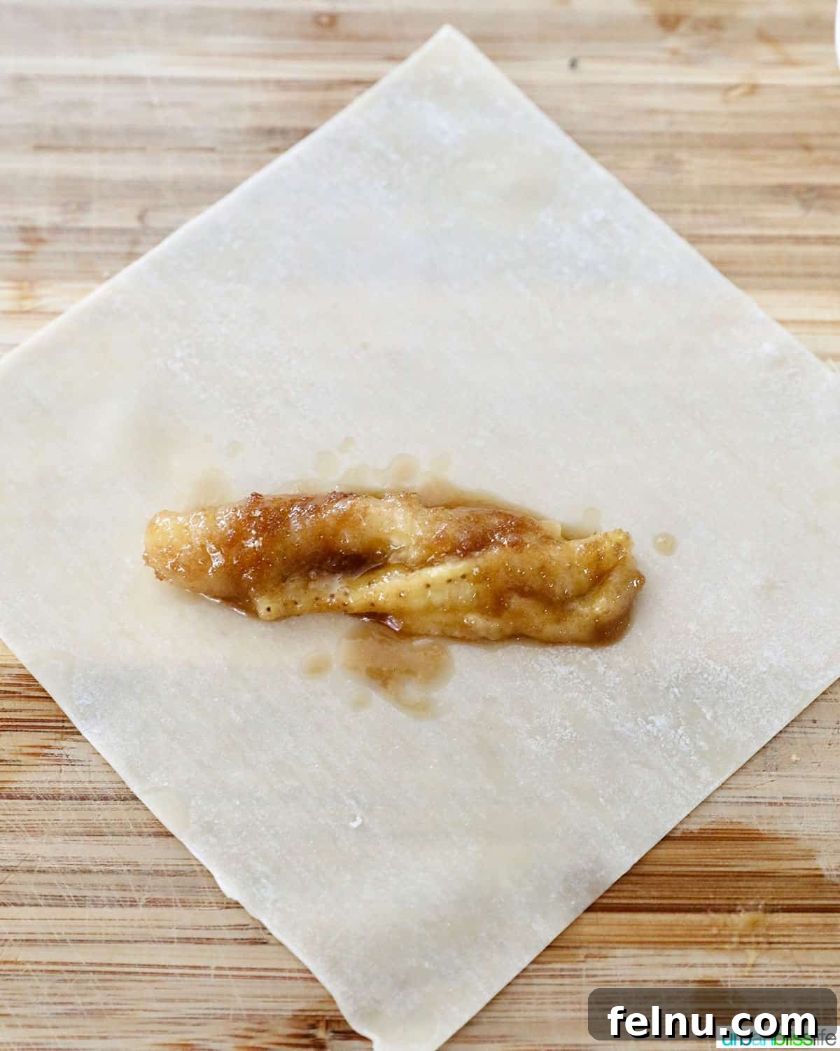 Effortless Filipino Turon: Crispy Banana Lumpia Perfection 10 Adding sugared bananas to wrapper to make Filipino turon banana lumpia.