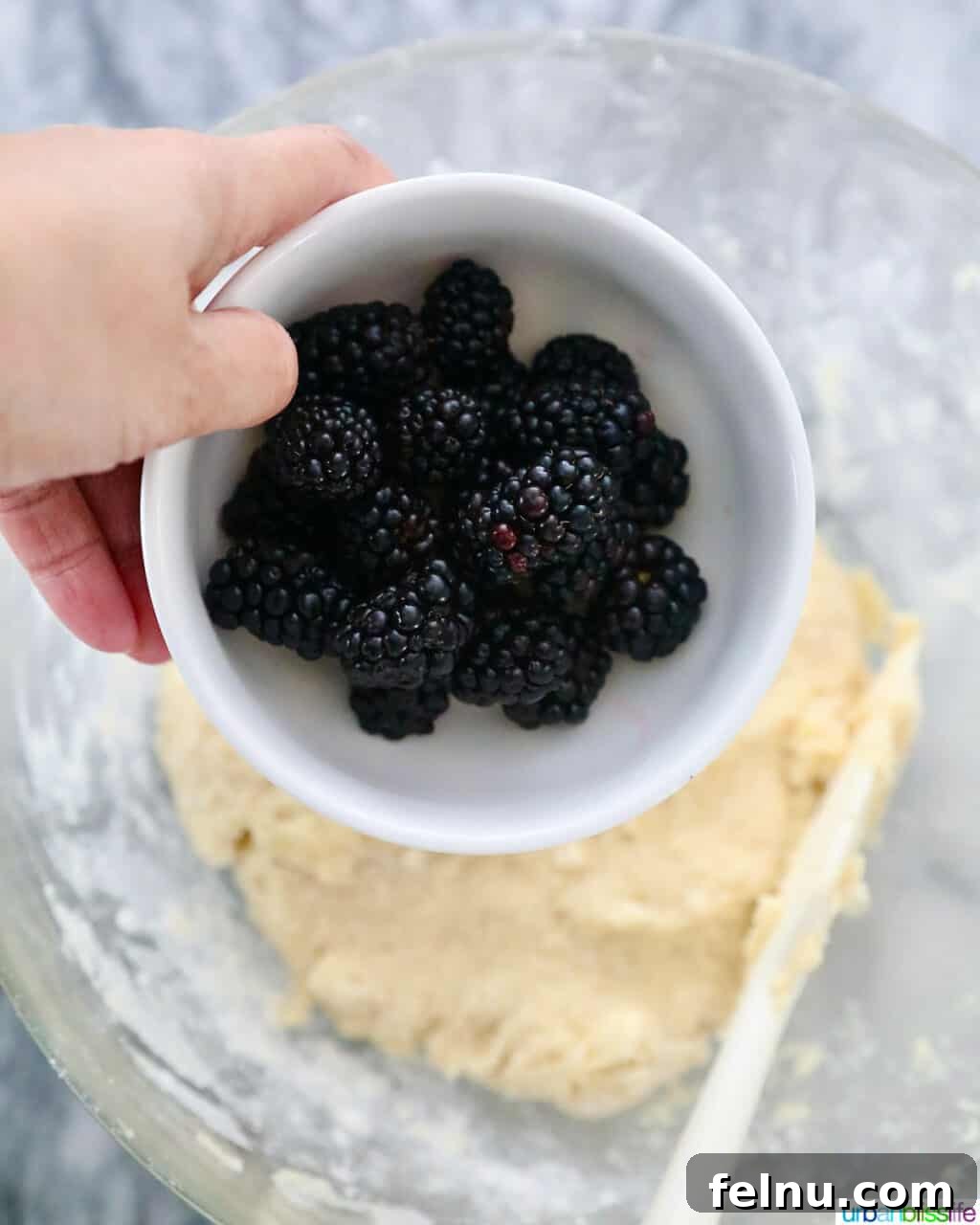 Adding blackberries to scones