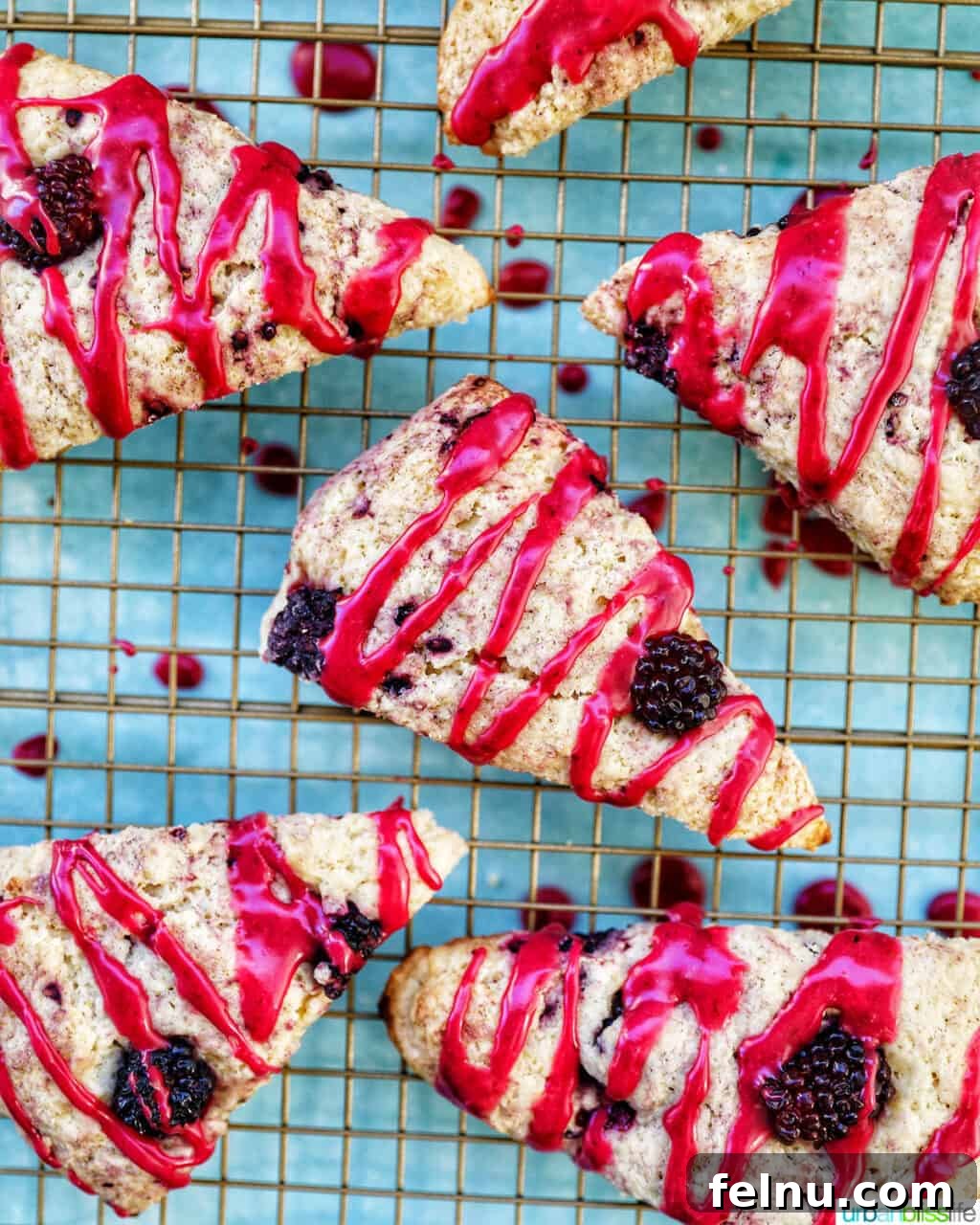 Blackberry Scones with Blackberry Glaze on a cooling rack
