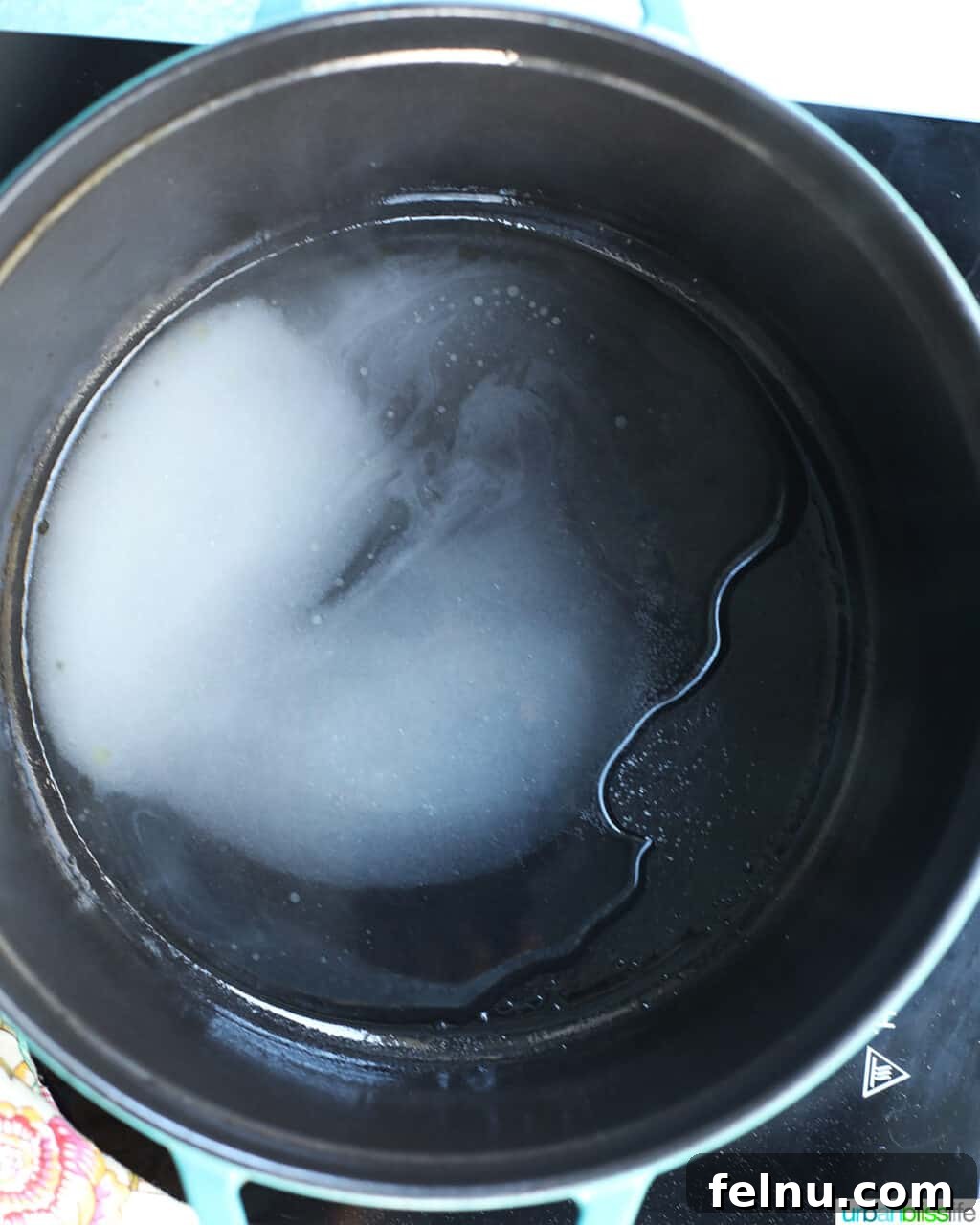 Raspberry Sparklers 7 Simple syrup simmering in a pot on the stovetop.