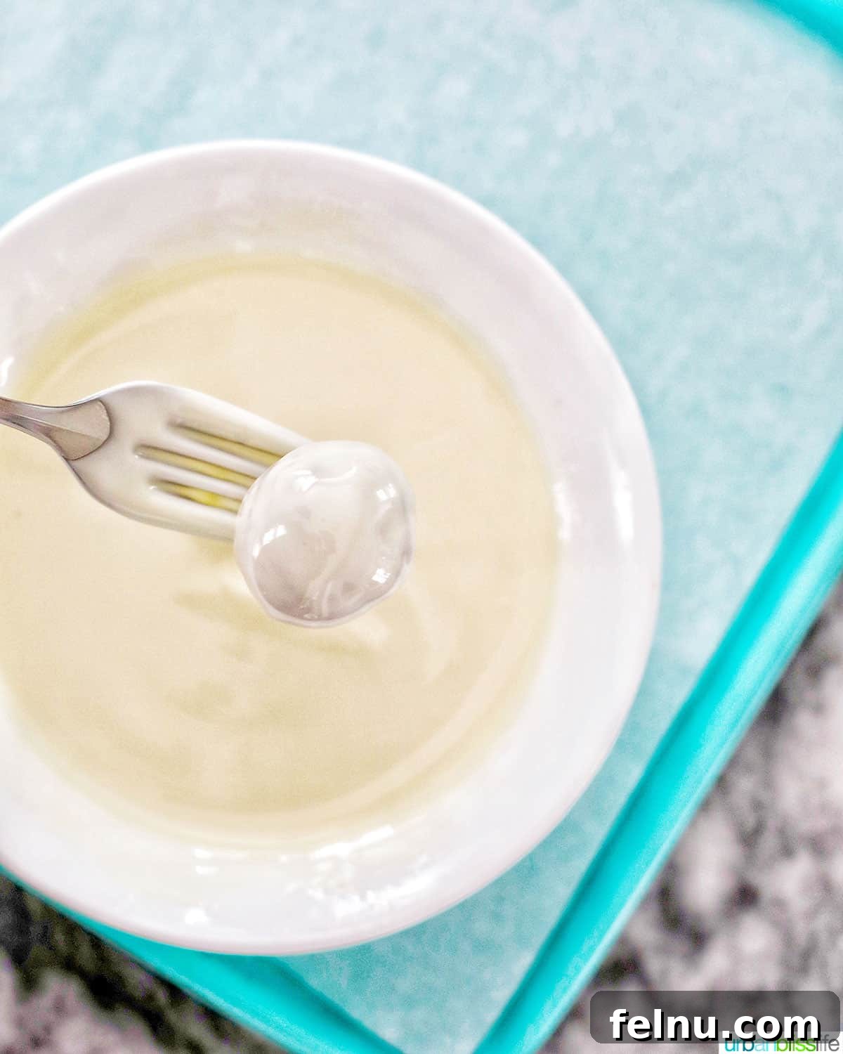Decadent Cookie Dough Delights 12 fork dipping cookie dough truffle into melted white chocolate