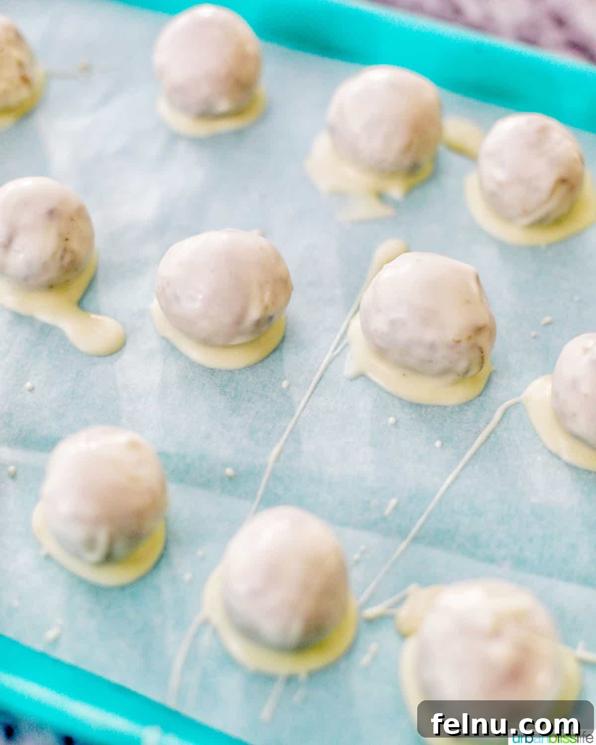 Decadent Cookie Dough Delights 13 white chocolate coated truffles setting on baking sheet