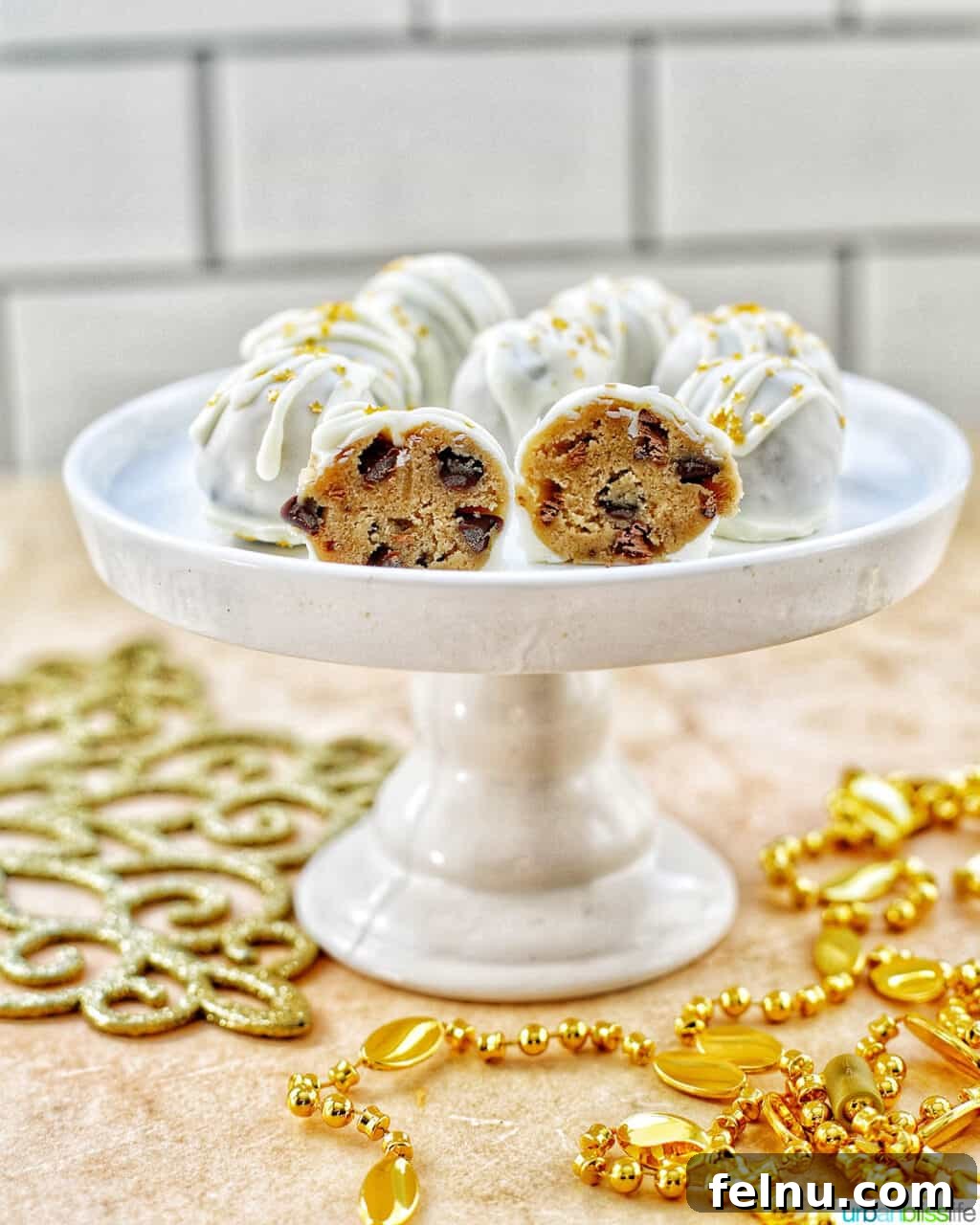 Decadent Cookie Dough Delights 4 gold decorated white chocolate coated cookie dough truffles cut in half