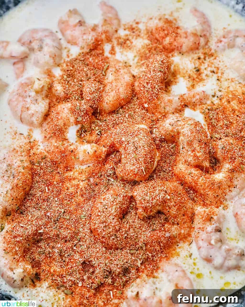 Mastering Homemade Cajun Flavor 5 adding cajun seasoning to shrimp pasta dish