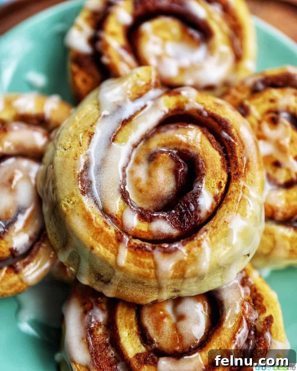 Golden Air Fryer Cinnamon Swirls 2 Perfectly iced air fryer cinnamon rolls ready to be enjoyed