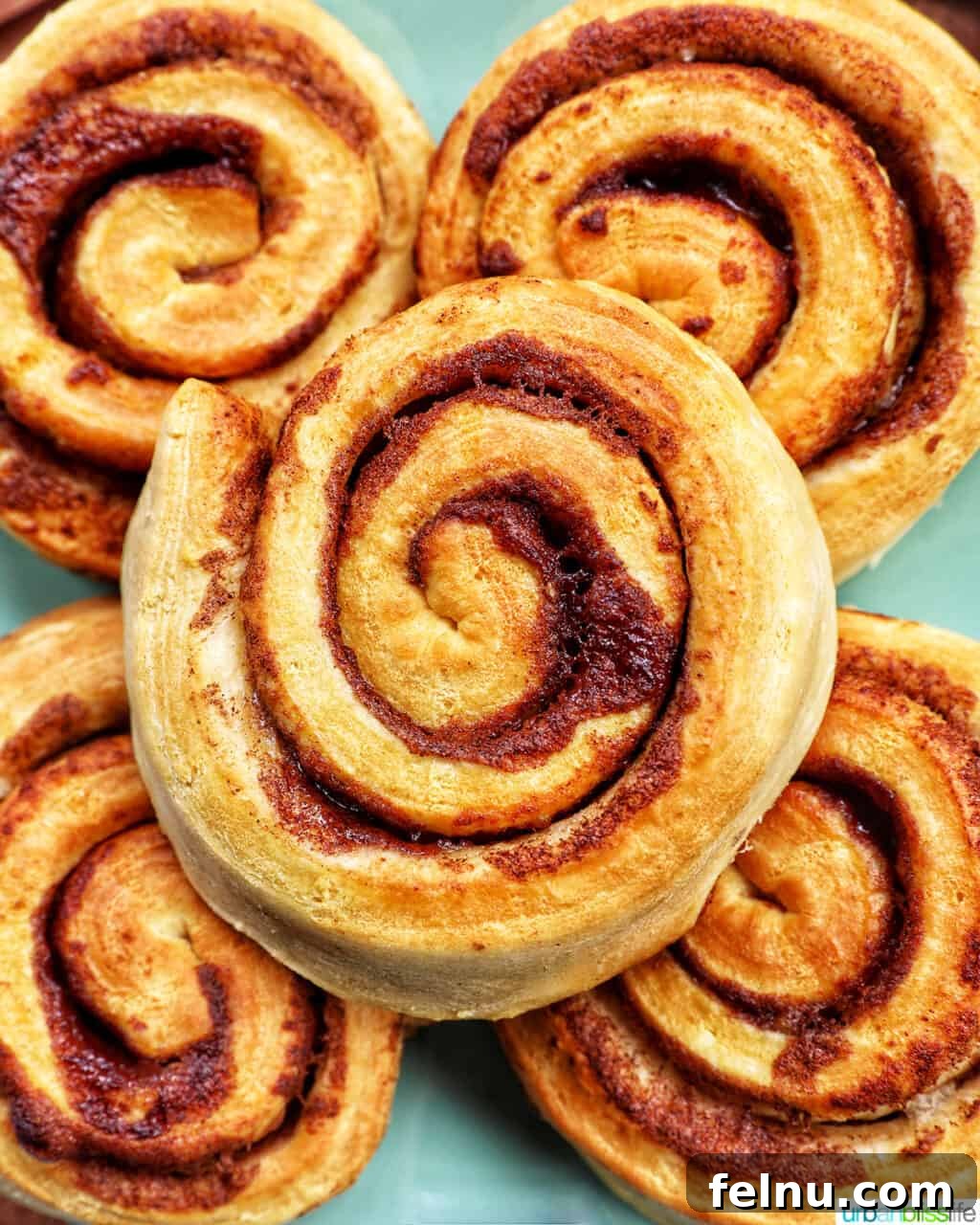 Golden Air Fryer Cinnamon Swirls 11 Uniced air fryer cinnamon rolls, showing their golden brown exterior