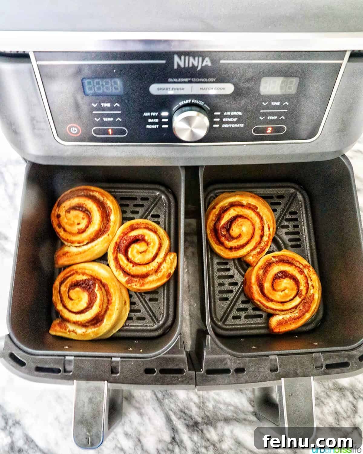 Golden Air Fryer Cinnamon Swirls 8 Finished air fried cinnamon rolls fresh out of the air fryer