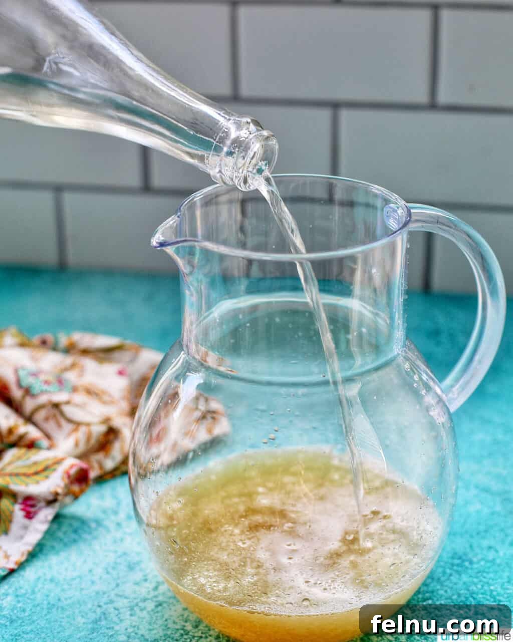 Sparkling Margarita Bliss 6 Pouring champagne into a pitcher with other margarita ingredients