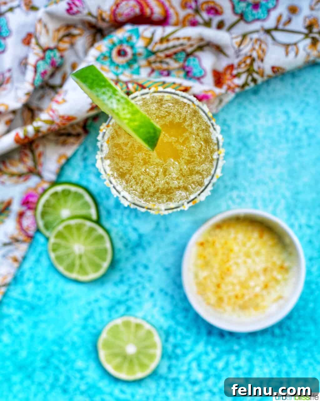 Sparkling Margarita Bliss 9 Overhead view of a glass of Champagne Margarita with lime slices and ingredients