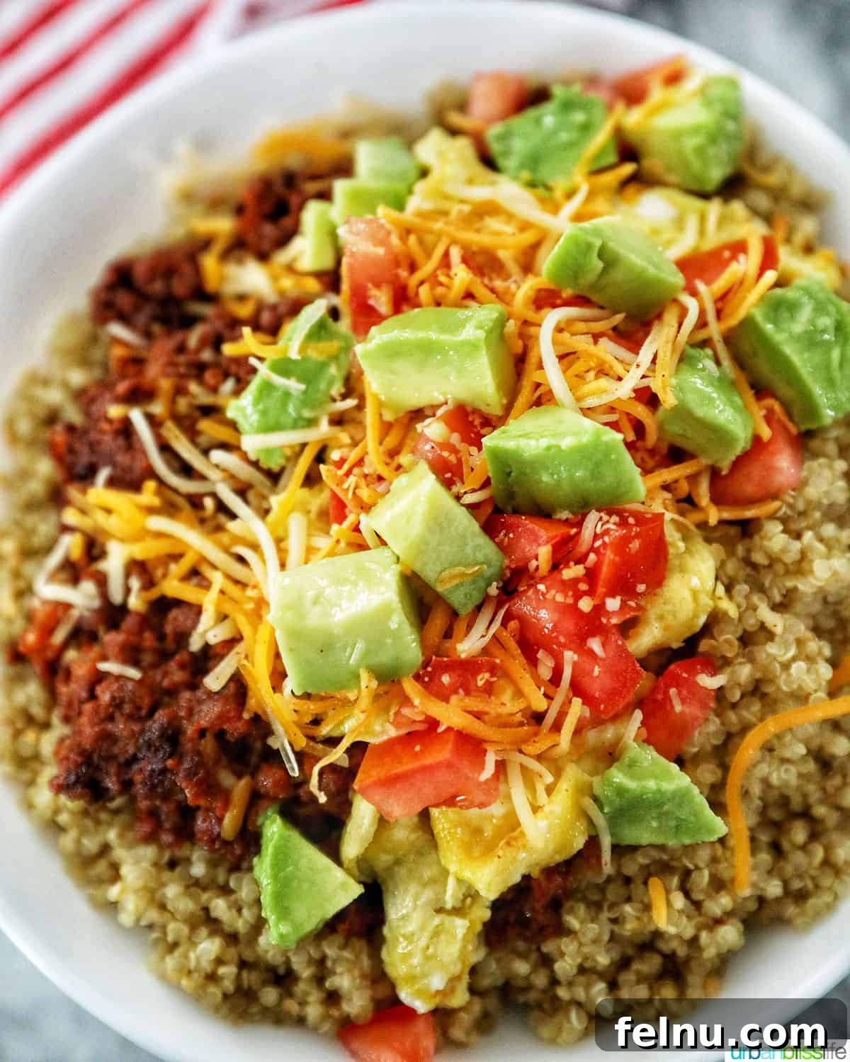 Adding avocados over Chorizo Breakfast Bowl