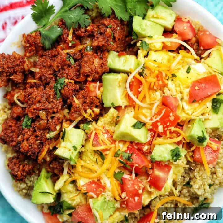 Chorizo breakfast bowl with avocado, tomatoes, and cheese.