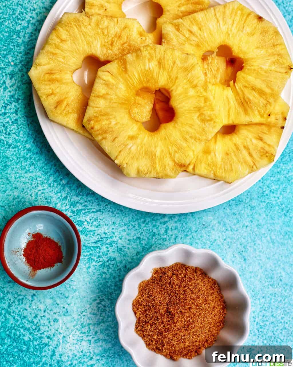 Golden Air Fryer Pineapple 4 Overhead view of air fryer pineapple ingredients: pineapple, brown sugar, cinnamon