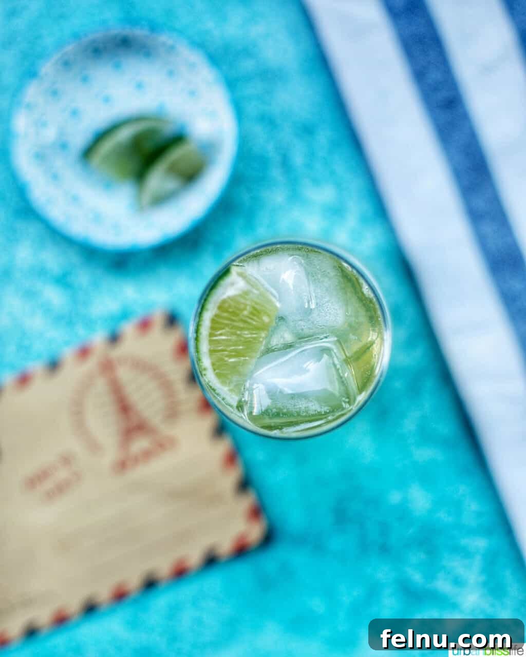 First Class Flight 3 Overhead shot of an Airmail Cocktail, showing its vibrant color and lime garnish.