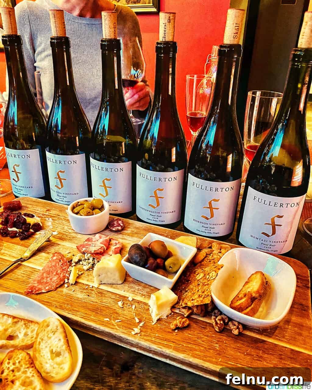 Fullerton Uncorked 3 An elegant lineup of Fullerton Wine bottles, showcasing their diverse range, accompanied by an assortment of gourmet snacks.