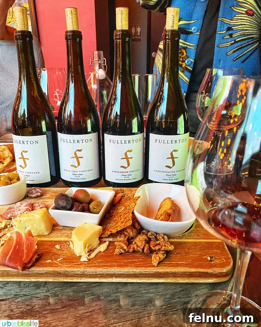 Fullerton Uncorked 10 A beautifully arranged wine flight featuring four glasses of Fullerton Wines, accompanied by an array of savory snacks, ready for tasting.