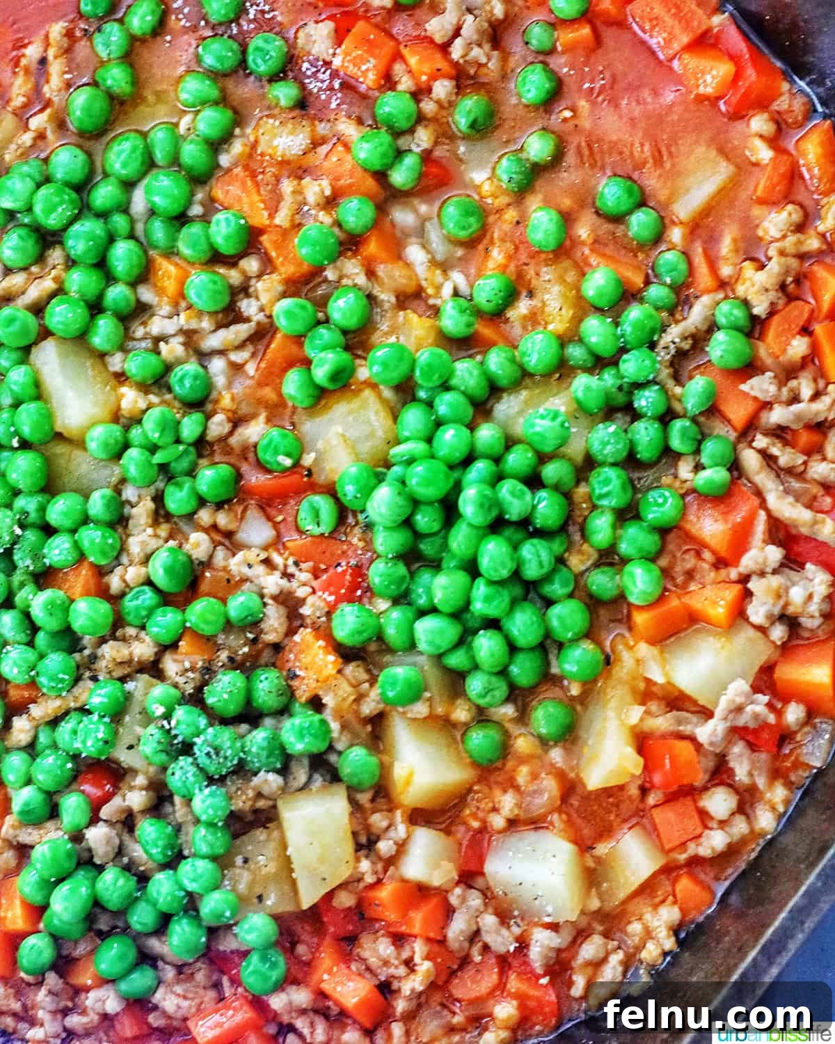 Ground Pork Menudo 8 Adding peas to menudo