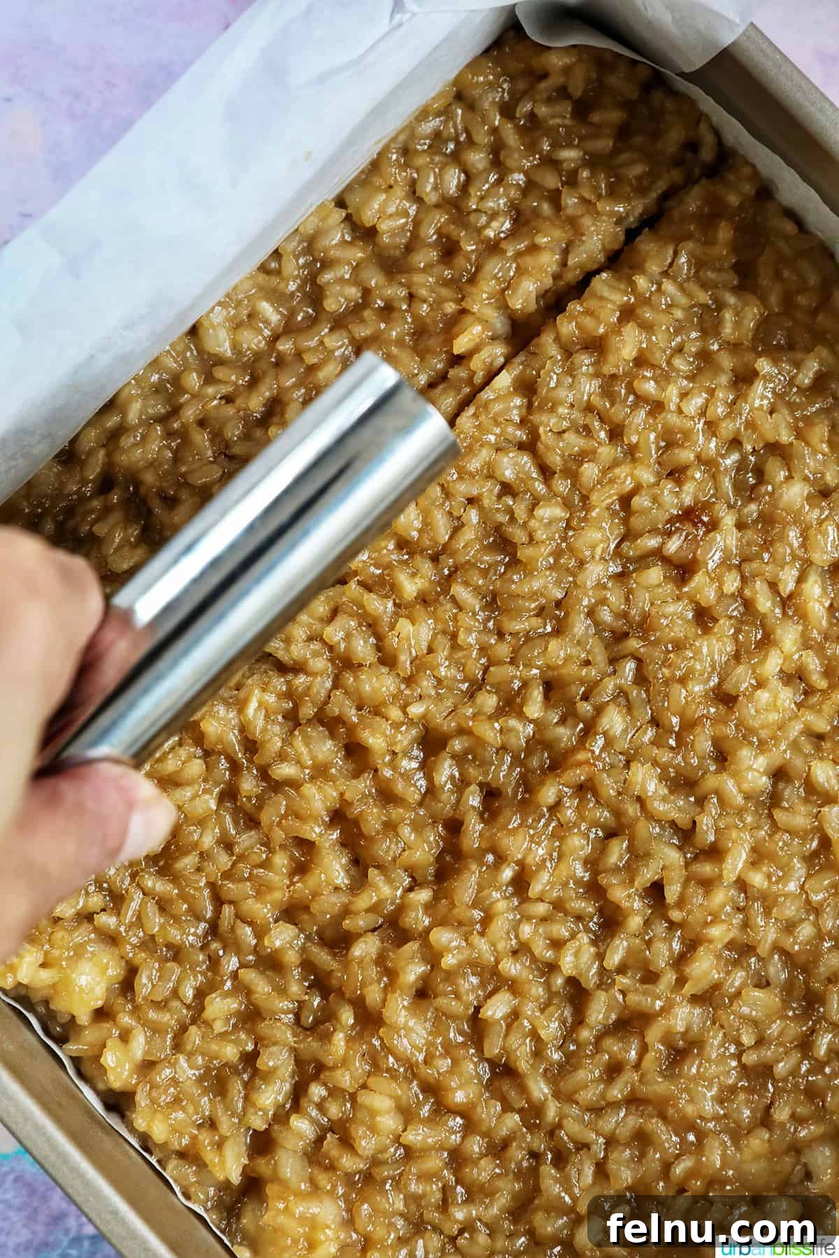Cutting the Filipino Biko dessert with a pastry cutter, ensuring clean and even slices.