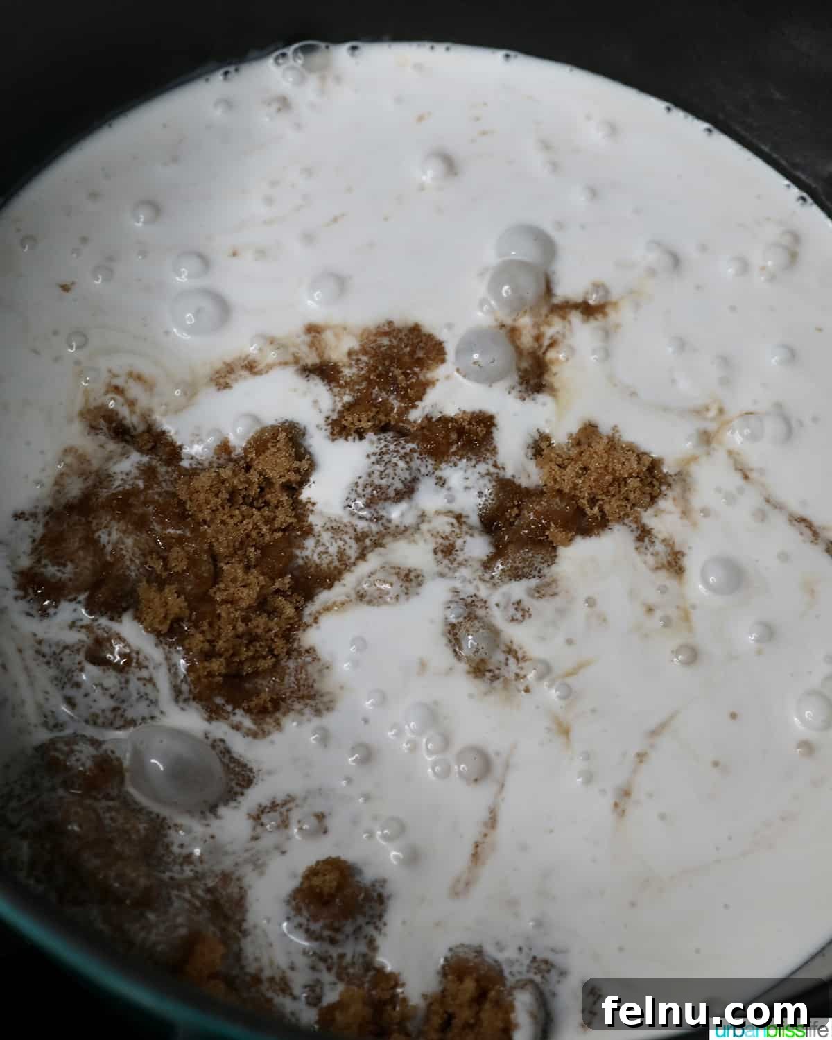 A mixture of coconut milk and brown sugar being prepared for Filipino Biko.
