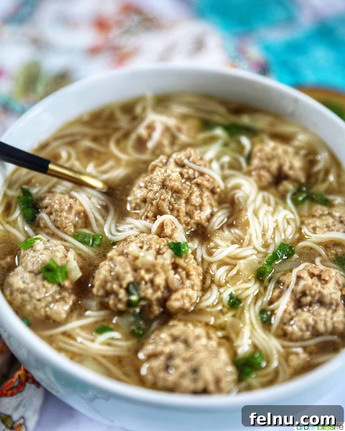 Filipino Almondigas soup with meatballs and rice noodles