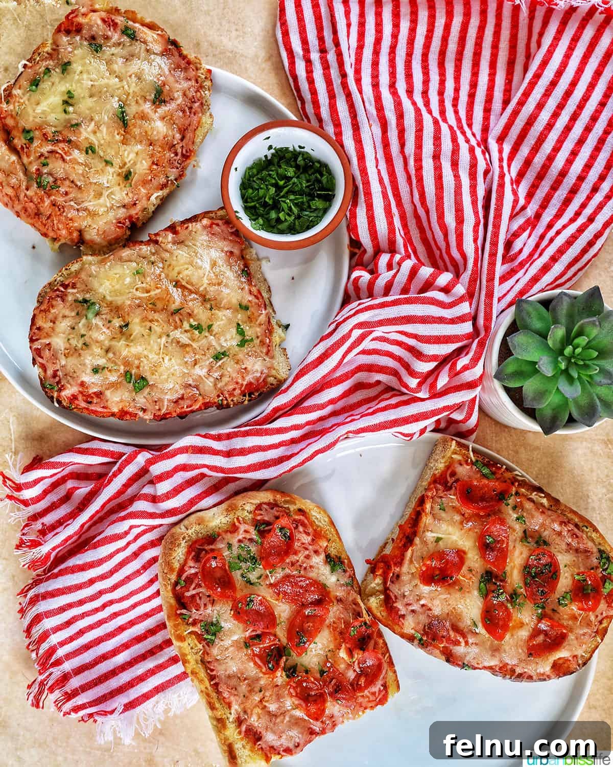 Crispy Air Fryer Pizza 15 A vibrant arrangement of cheese French bread pizza slices and pepperoni French bread pizza slices, artfully placed at angles on a marble table with a red striped napkin.