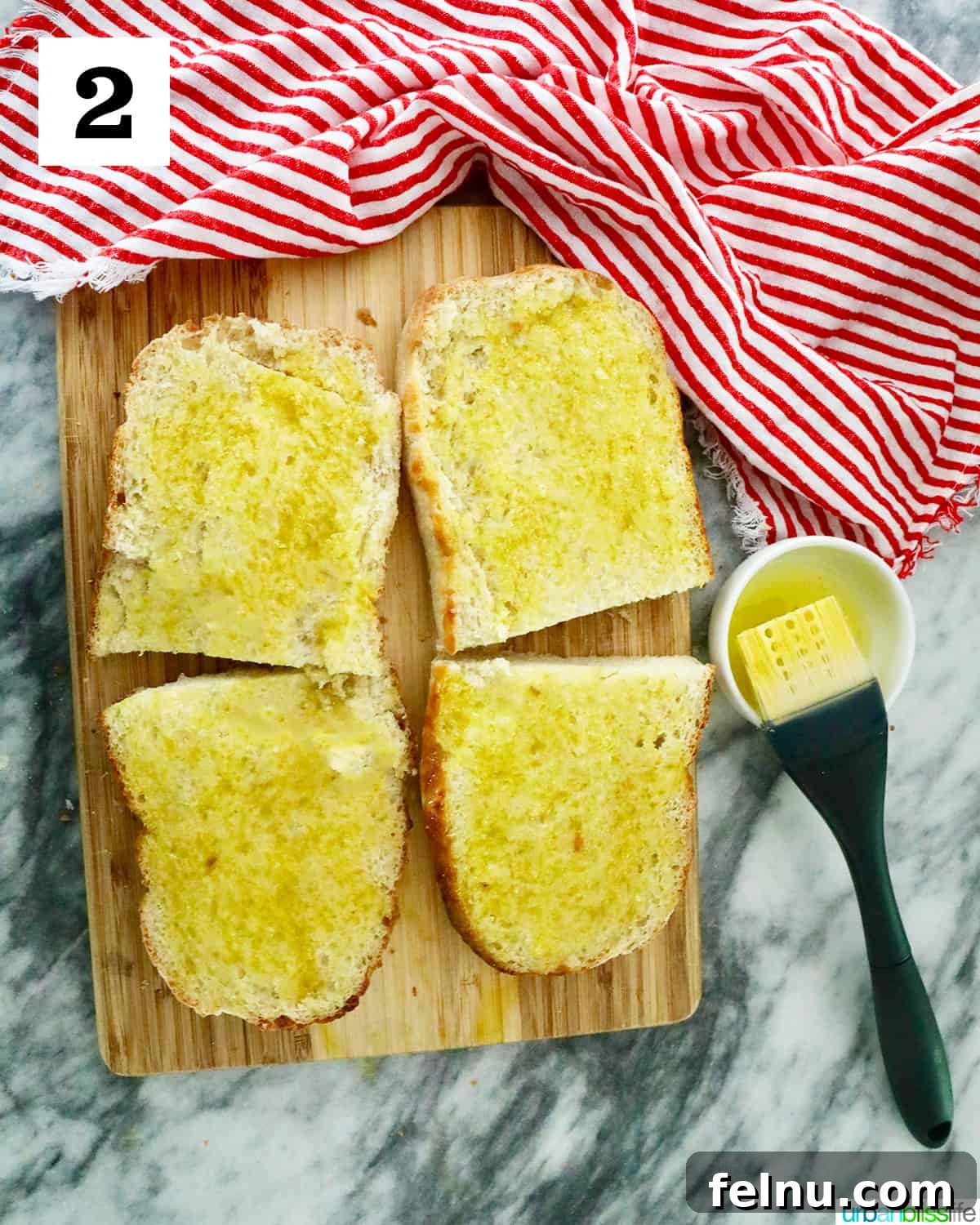 Crispy Air Fryer Pizza 6 Four sliced halves of French bread on a cutting board, each generously brushed with olive oil, ready for the next step in making air fryer pizza.