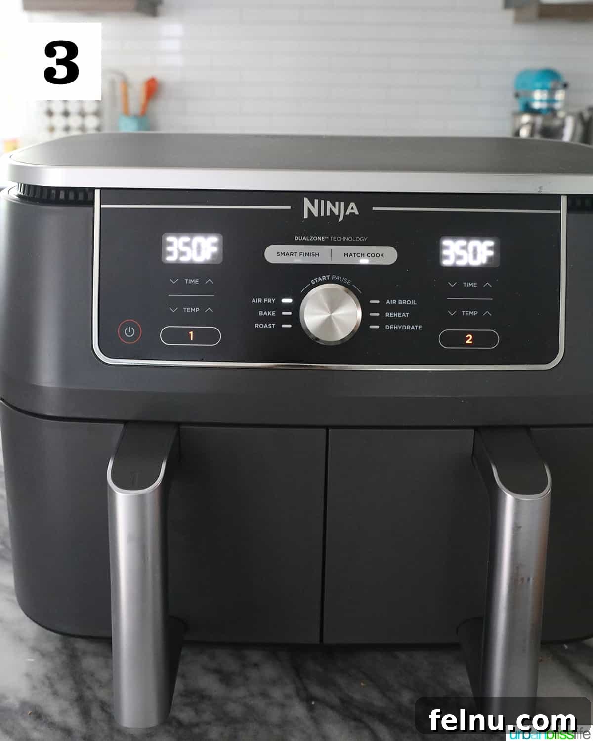 Crispy Air Fryer Pizza 7 A Ninja Foodi dual air fryer displaying a temperature of 350 degrees, sitting on a sleek marble countertop, prepared for cooking.