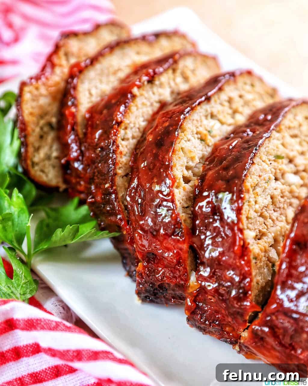 Air Fryer Meatloaf Magic 2 Glazed air fryer meatloaf slices on a white plate