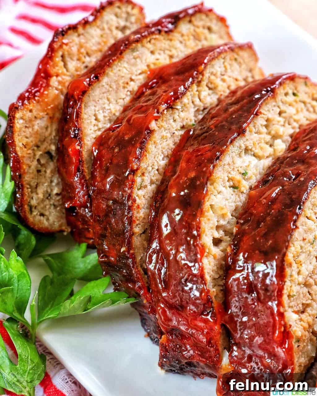 Air Fryer Meatloaf Magic 14 Sliced meatloaf on a plate with greens