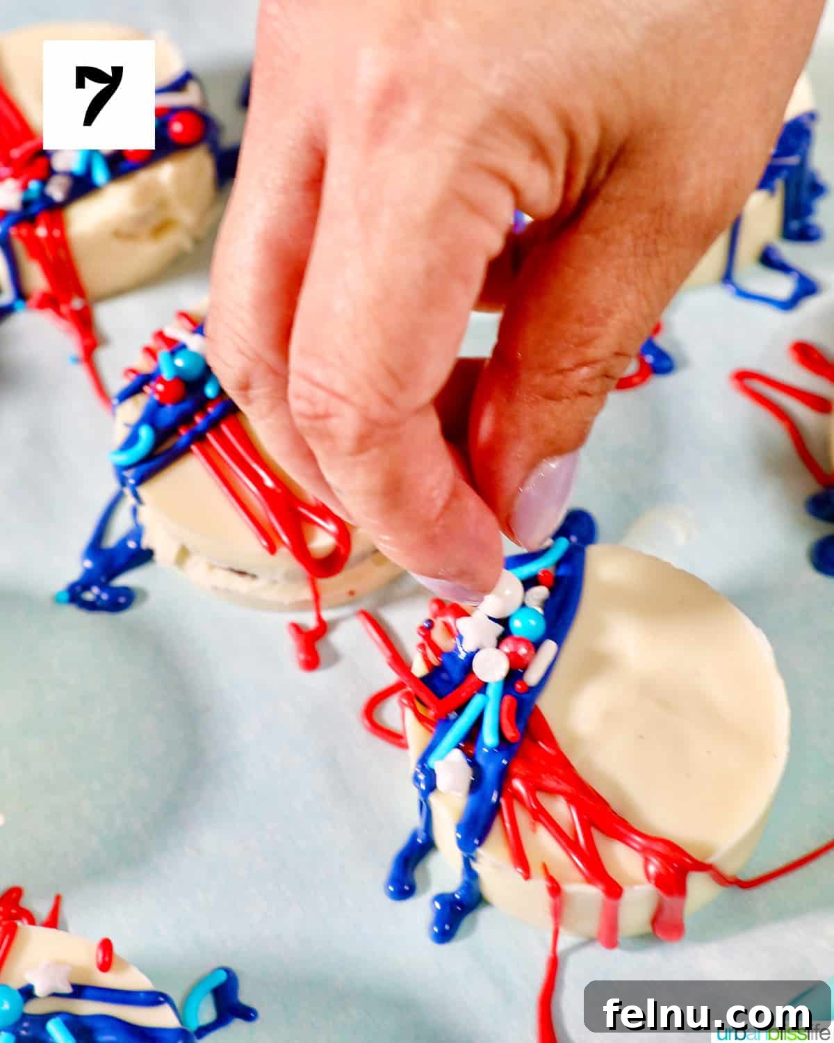 Fourth of July-Themed Oreo Delights 13 Hand sprinkling red, white, and blue sprinkles onto frosting of 4th of July Oreos.