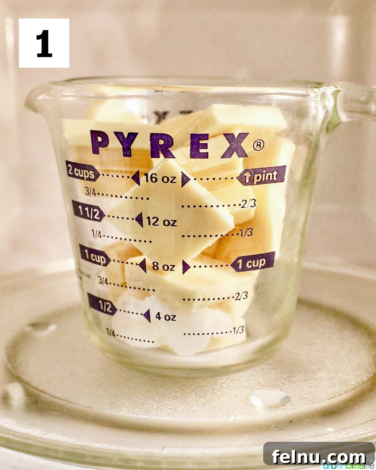 Fourth of July-Themed Oreo Delights 5 White chocolate pieces in a microwave-safe glass measuring cup.