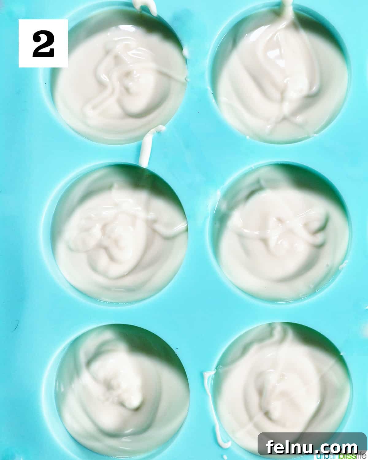 Fourth of July-Themed Oreo Delights 6 White chocolate poured into a blue chocolate candy mold.