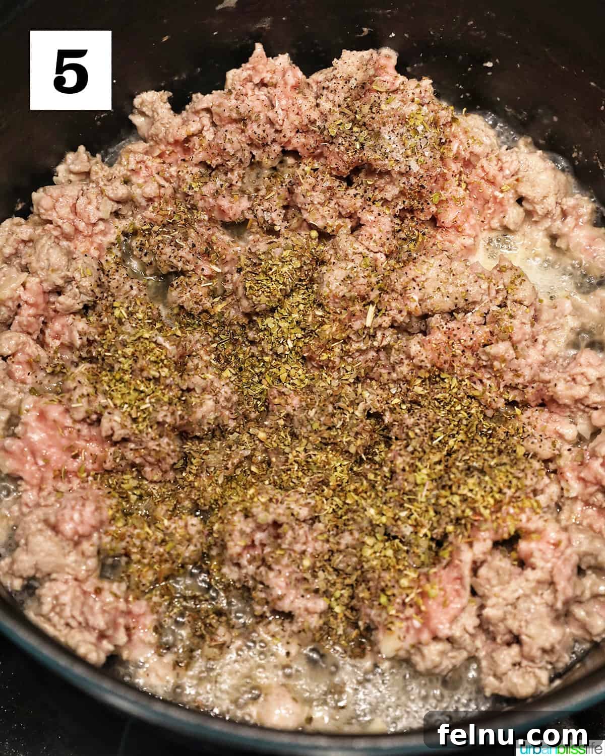 Creamy Vegan Lasagna 14 dried basil and oregano added to ground turkey in a dutch oven.