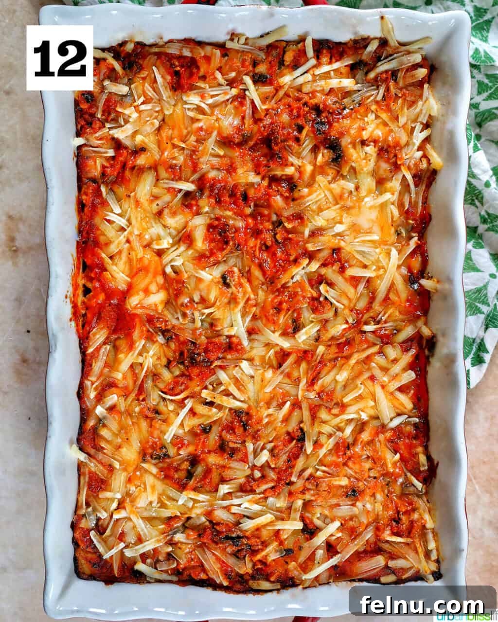 Creamy Vegan Lasagna 24 baking dish with baked dairy free lasagna inside topped with melty dairy free cheese.