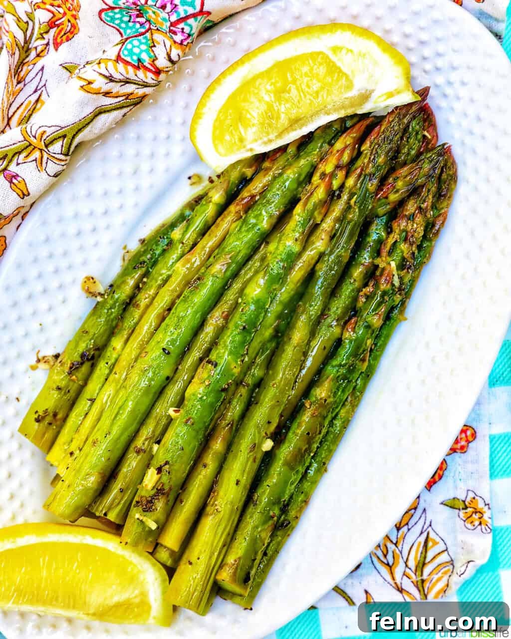 Close up of Grilled Asparagus with Lemon Wedges
