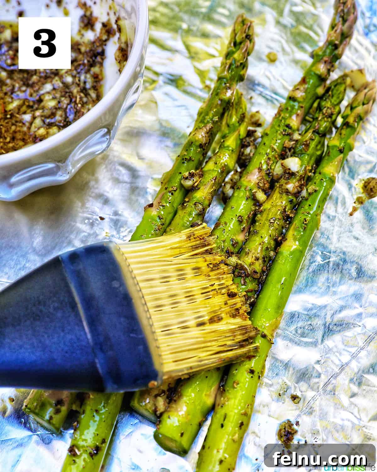 Brushing asparagus with herb mixture