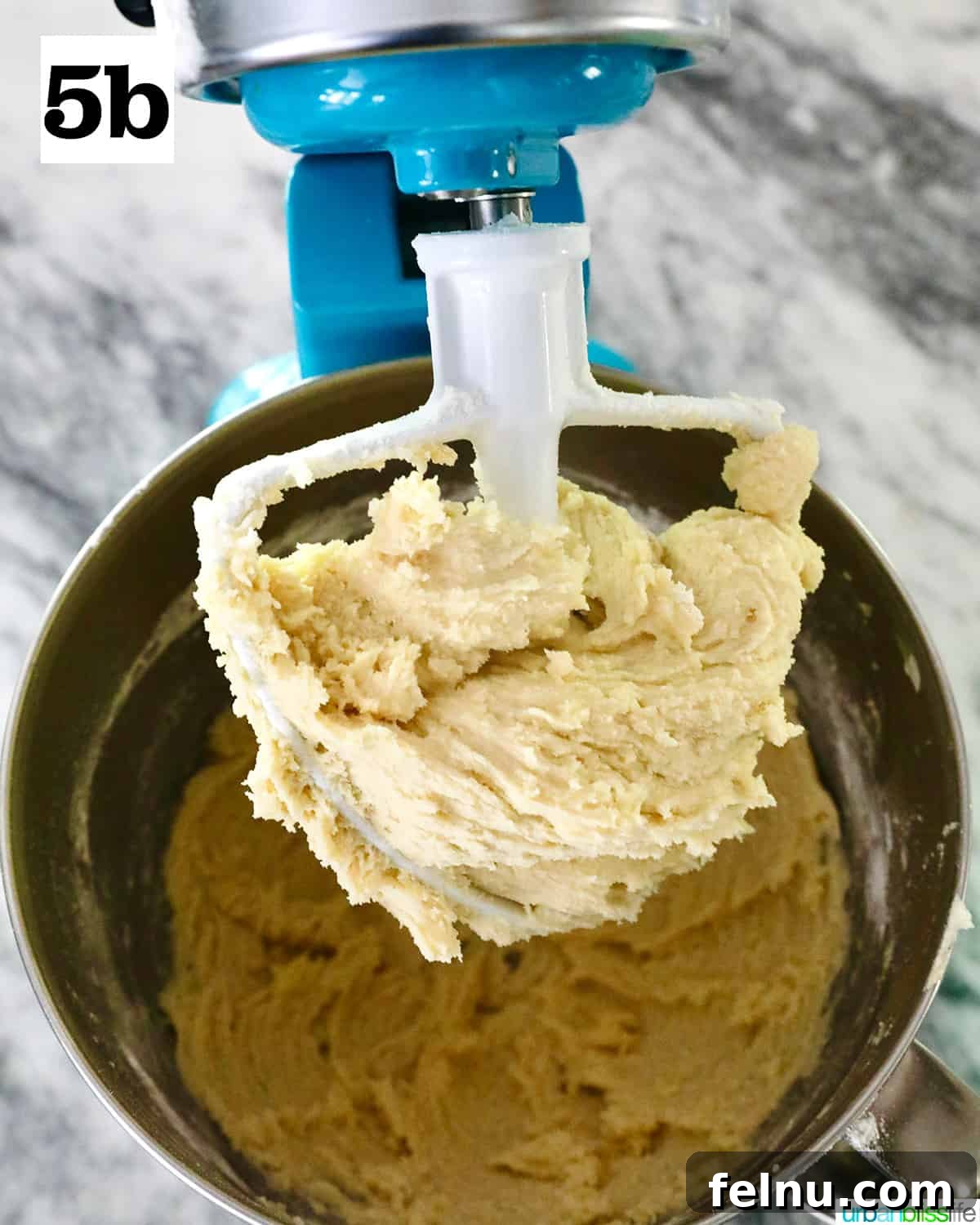 Tangy Key Lime Delights 13 A stand mixer paddle attachment coated with creamy, consistent key lime cookie batter, indicating successful mixing.